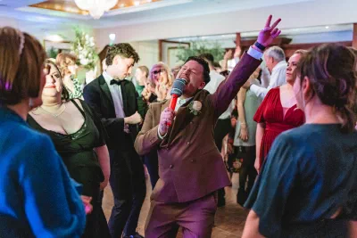 Groom singing into microphone during a Dublin wedding reception