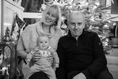 Family photography session in a Dublin park, parents with toddler in natural surroundings