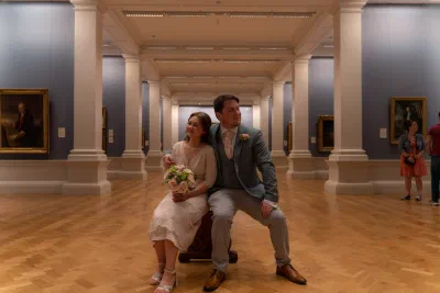 Couple seated together during their wedding at the National Gallery of Ireland, Dublin