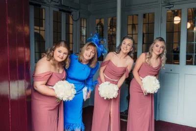 Bridesmaids in dusty rose gowns with mother of bride at Irish church