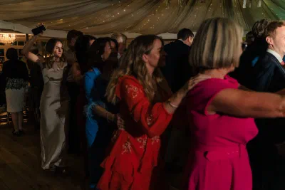 Packed wedding dancefloor at The Millhouse under warm light