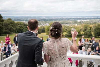 Bride and groom toasting their guests from the terrace at Orlagh House overlooking Dublin
