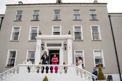 Speeches on the front steps of Orlagh House, guests gathered below the Georgian facade