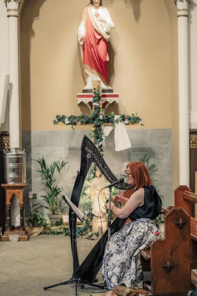 Harpist playing beside the altar before a wedding ceremony