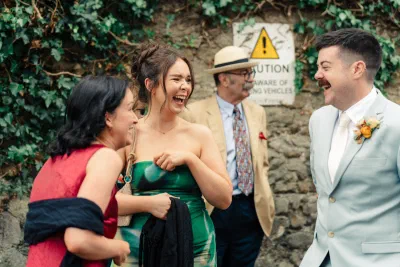 Candid moment of wedding guests laughing, documentary wedding photography Ireland